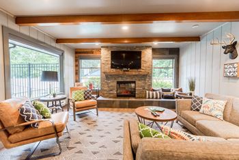a living room with couches and chairs and a fireplace